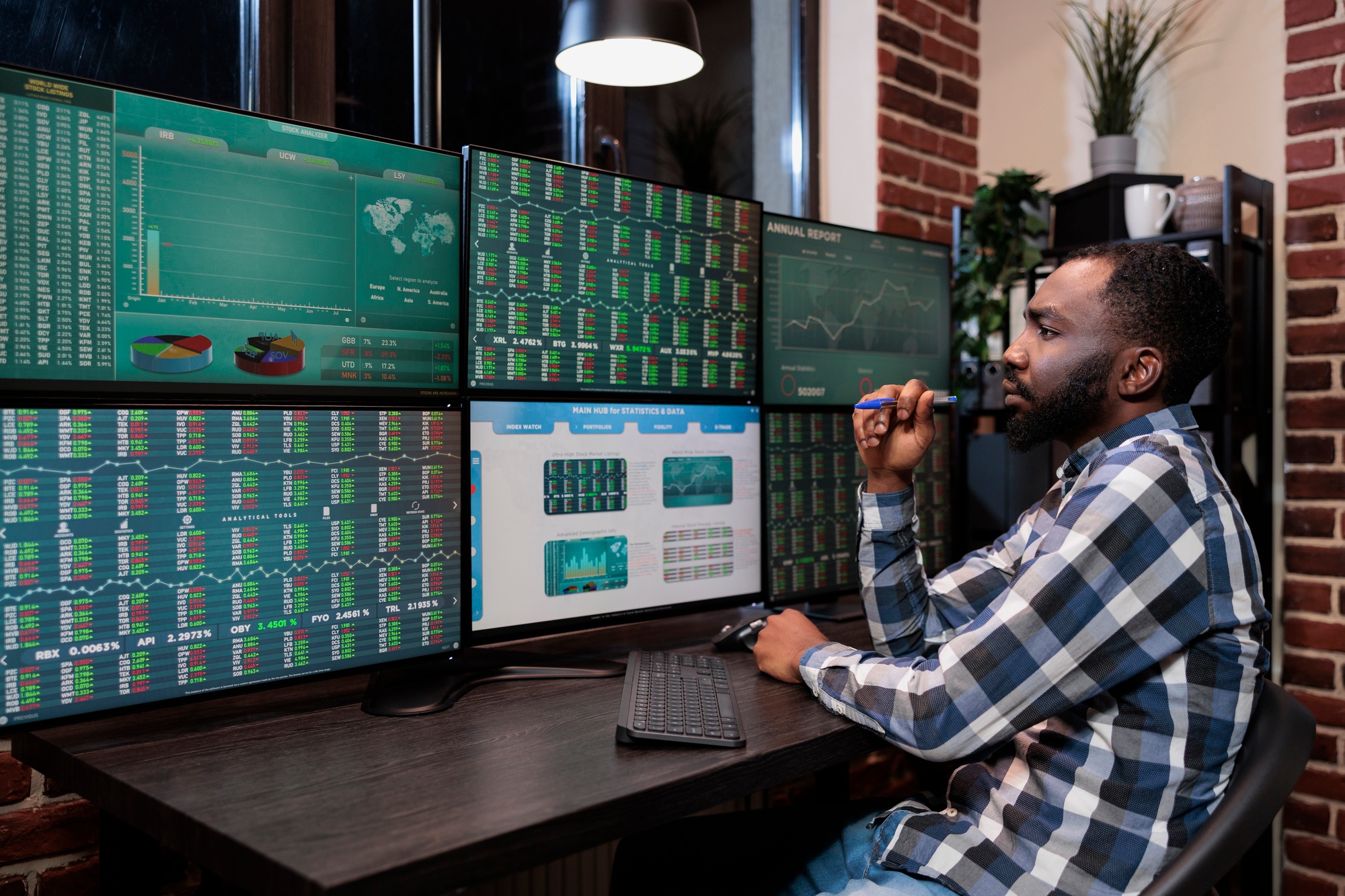 Attentive forex stock market professional trader sitting at multi monitor workstation while looking