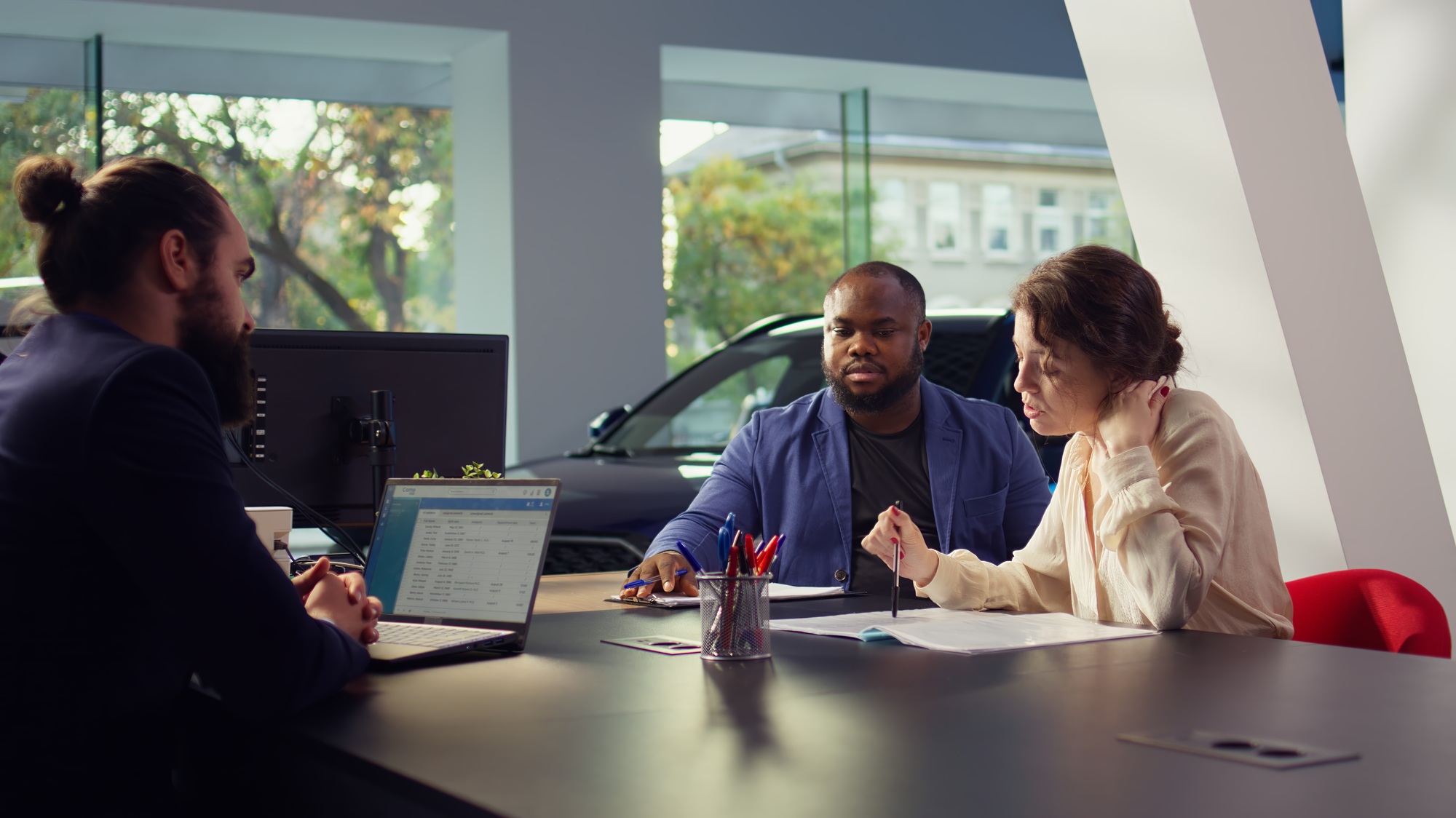 Car showroom salesman providing flexible financial options to entice clients